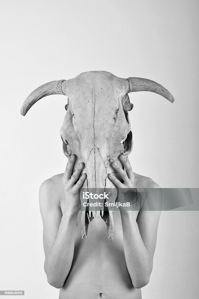 young man holding skull Black and white photo of man holding skull 18-19 Years Stock Photo