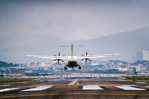 Rear view passenger aircraft landing in airport