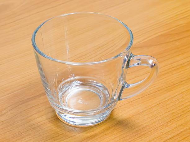 istock empty clear glass cup on wooden floor 1588644204