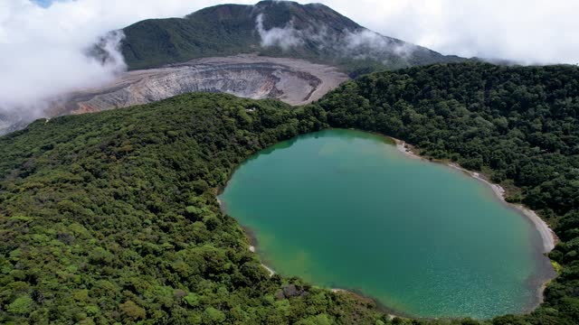 Beautiful aerial cinematic view of the Poas Volcano crater and lagoon in the National Park in Costa Rica