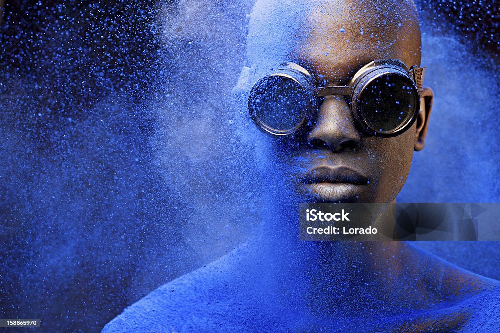 close up of black man covered with blue pigment Colors Stock Photo
