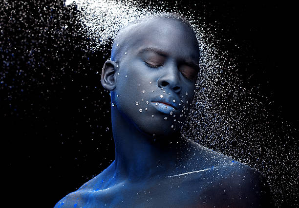 close up of black male model with blue make-up close up of black male model with blue make-up crazy makeup stock pictures, royalty-free photos & images