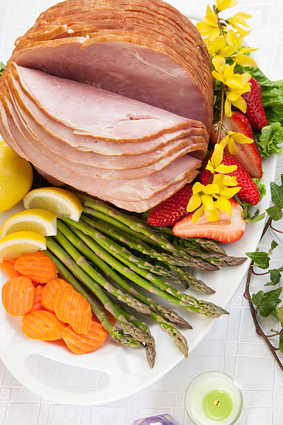 istock Big piece of ham with vegetables and fruit on white plate 158869979