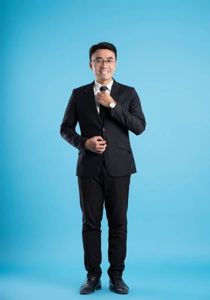 istock full body image of young businessman posing on blue background 1588714362