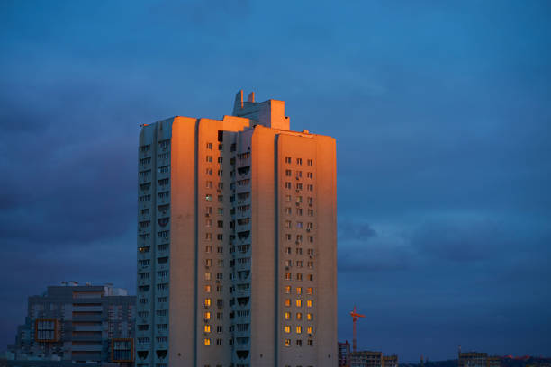 istock Evening city at sunset. An old panel building illuminated by the sun's rays. 1588727292