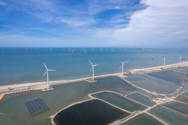 Aerial view of fishing and aquaculture farms and wind turbines Aerial view of fishing and aquaculture farms and wind turbines floating electric generator stock pictures, royalty-free photos & images