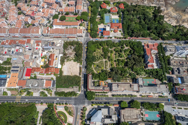 istock Vertical aerial view of densely populated urban houses and greenery 1588754607