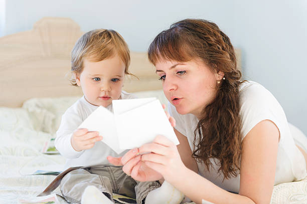 Mother and her son with paper cards stock photo