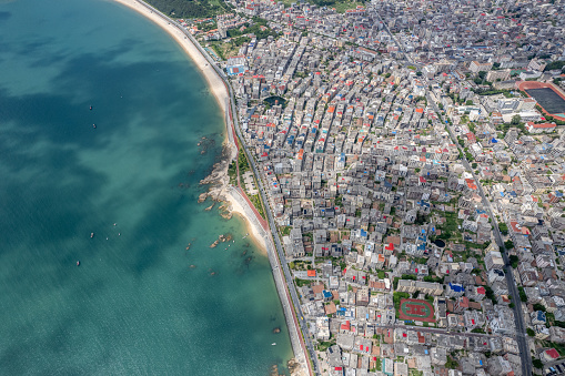 An aerial view of densely populated town buildings by the seaside