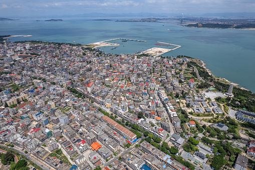 An aerial view of densely populated town buildings by the seaside