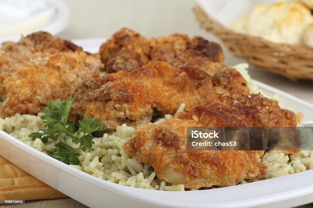 Baked Chicken Closeup of baked chicken thighs and rice in a serving dish Baked Stock Photo