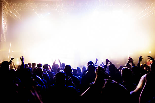 istock A crowd at a concert with bright lights and fog 158877692