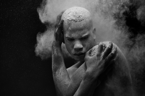 powder splashing on black male model