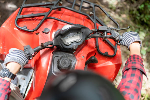 POV of young man drives all terrain vehicle on muddy track