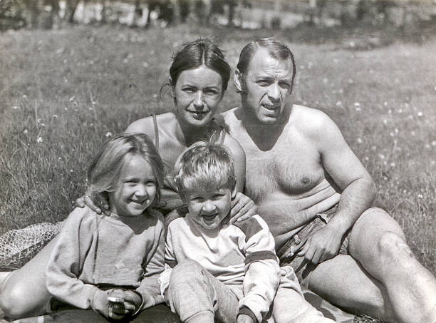 Vintage photo of young couple with children in garden stock photo