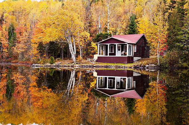 istock Reflections autumn forest house in lake 158882701