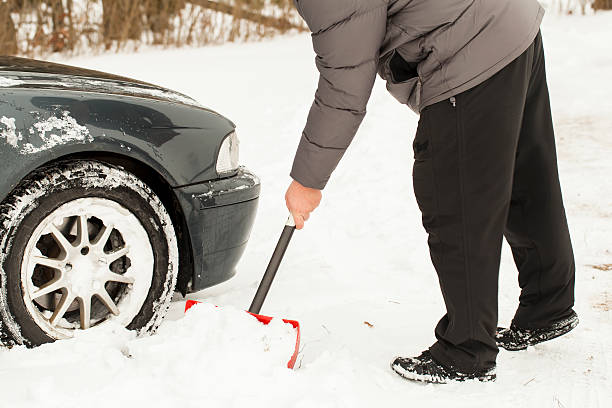 istock Man with a snow shovel near car 158882929