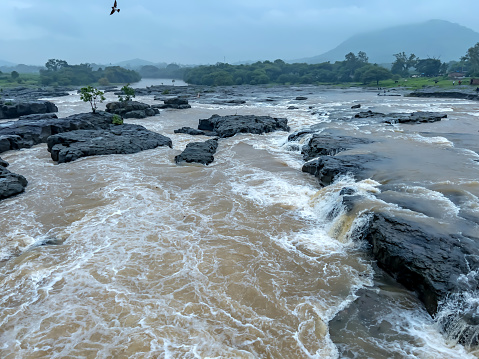 The raging Indrayani River at Kundmala near Pune India during the monsoons. Monsoon is the annual rainy season in India from June to September.