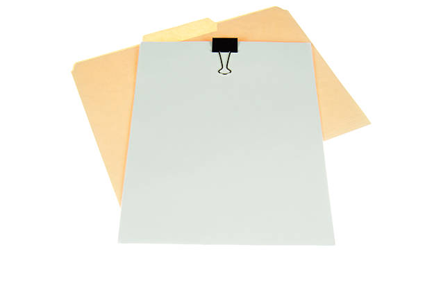 Paper and Folder Stack of white paper clipped together on manila folder isolated on white background. manila folder and paper clip stock pictures, royalty-free photos & images