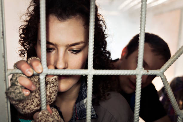 istock Sad Woman Behind Bars 158888315