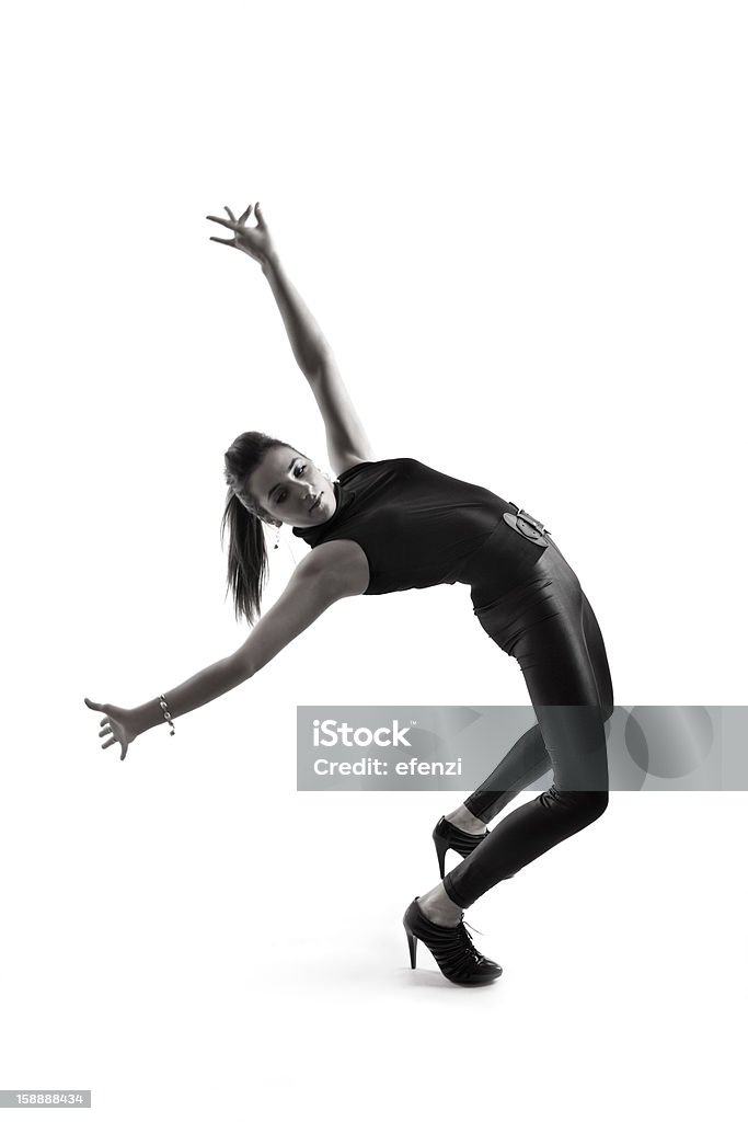 Flexible Woman Doing Back-bend Young flexible female dancer in black tight clothes doing back-bend, isolated on white background, B&W. Adult Stock Photo