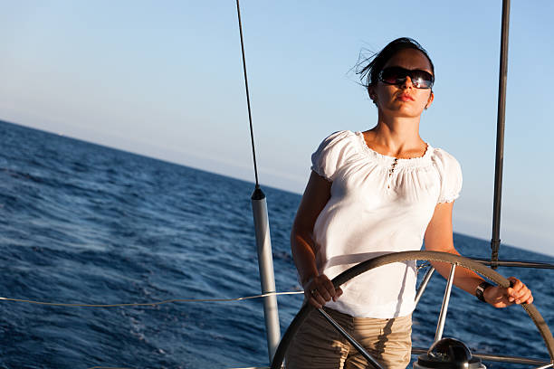 istock Young Woman Steering Yacht 158888475
