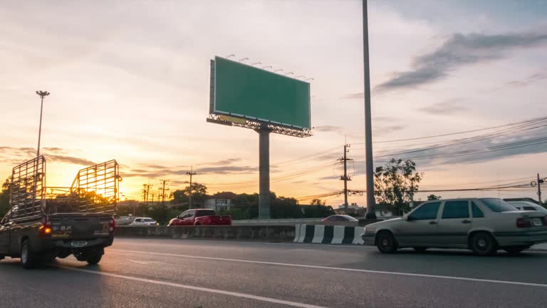 Time lapse of a billboard on a busy evening street.