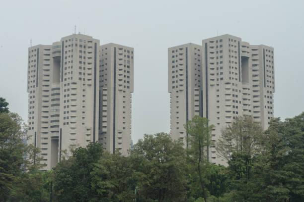 istock Apartments high rise building covered with trees 1588957400