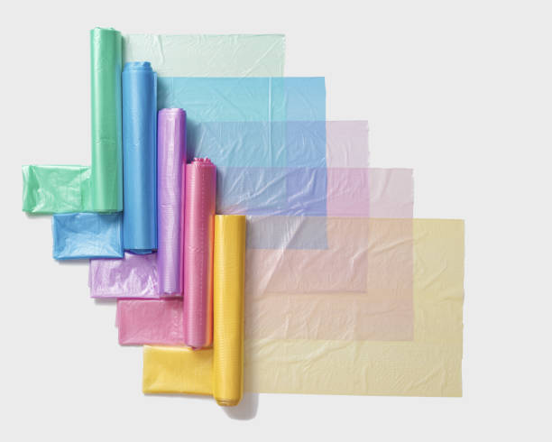 Colorful plastic bags in rolls as geometric pattern on white Eco plastic product bio bags for food, Plastic free environment protection concept, eco trend to reduce disposable plastic