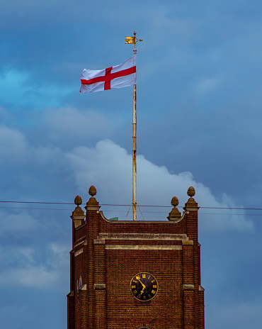 A English flag in Kingston Upon Thames, with a stormy sky at dusk.