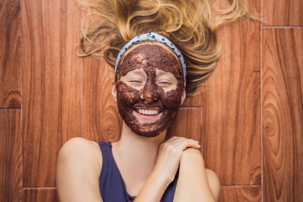 istock Young woman with algae facial mask lying on the floor 1588963241