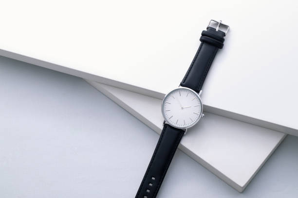 istock Watches with brown and black leather strap on white office desk 1588965374
