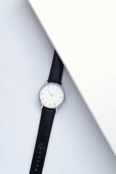 istock Watches with brown and black leather strap on white office desk 1588965391