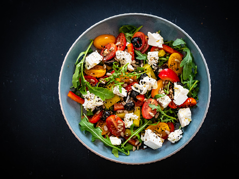 Feta cheese salad - feta with fresh vegetables on wooden table