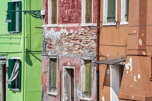 Old worn out colorful buildings in Burano, Venice.