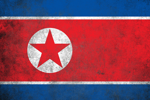 North Korea flag on grunge textured background