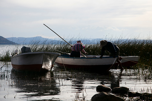 Taquile, Peru; 1st January 2023: Local fishermen from the Llachon peninsula working on the shores of Lake Titicaca.