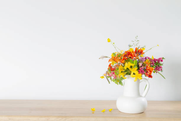 istock summer flowers in white jug on wooden table 1589047811
