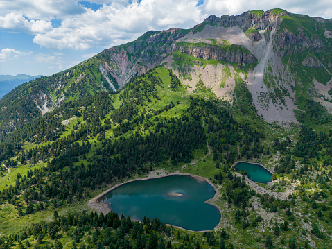 Aerial view of the summit cross on the snowcapped mountain Diedamskopf in Vorarlberg