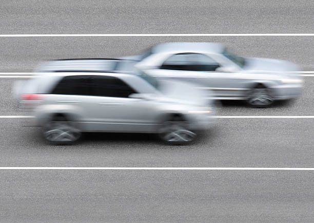 Cars on the road Cars drive on the road overtaking each other street racing stock pictures, royalty-free photos & images