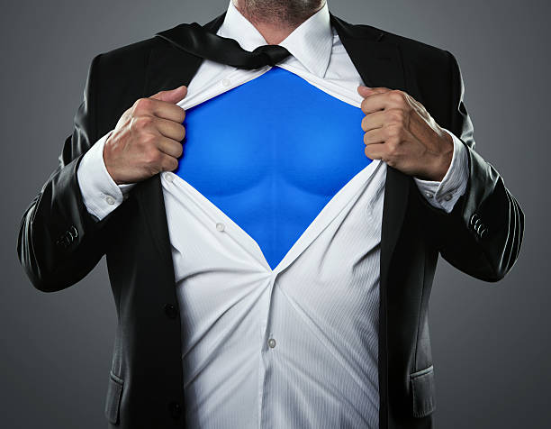 Businessman hero Young businessman acting like a super hero and tearing his shirt off with copy space chest torso photos stock pictures, royalty-free photos & images
