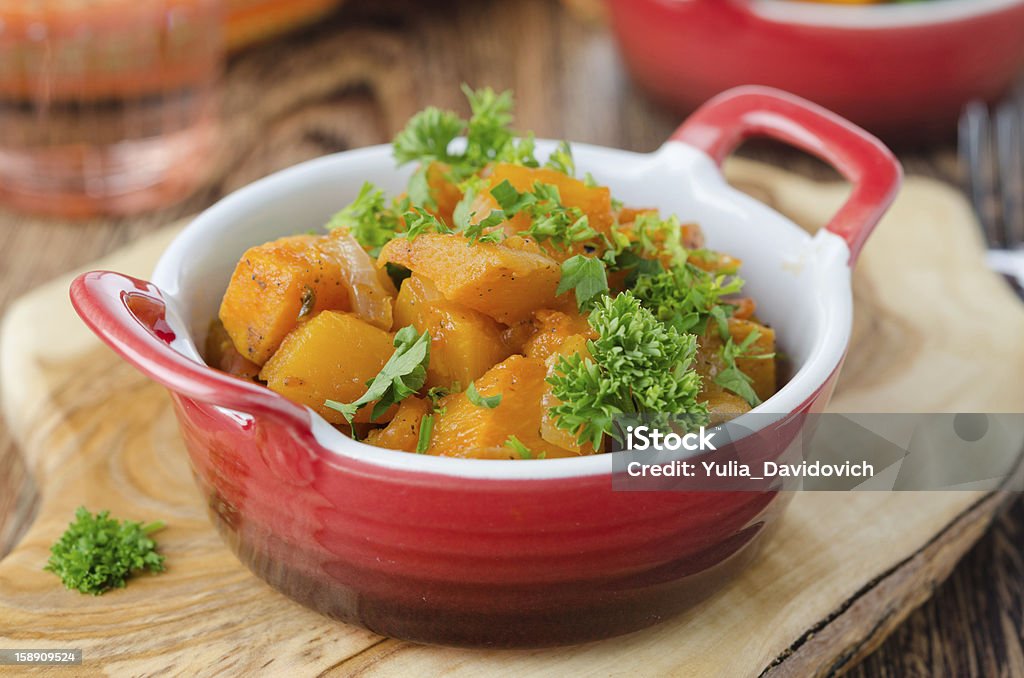 pumpkin baked in a tomato sauce with garlic pumpkin baked in a tomato sauce with garlic and herbs closeup Appetizer Stock Photo