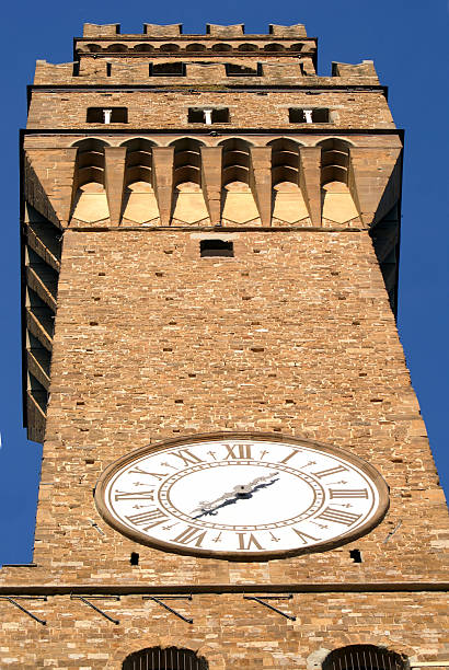 Palazzo Vecchio's Tower shot of the tower of palazzo vecchio in piazza della signoria in florence. palazzo vecchio stock pictures, royalty-free photos & images