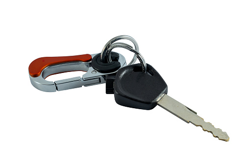 Black motorcycle keys with keychain isolated on white background with copy space and clipping path.