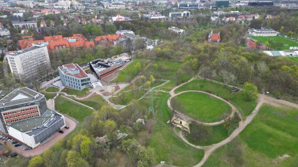 istock a view from a helicopter looking down onto a grassy park in a town 1589102954