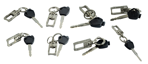 Big set of motorcycle keys with keychain isolated on white background with copy space and clipping path.