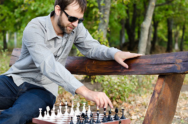 istock Man playing chess on a wooden bench 158913139