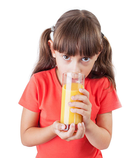istock Little girl with an appetite drinking juice 158913152