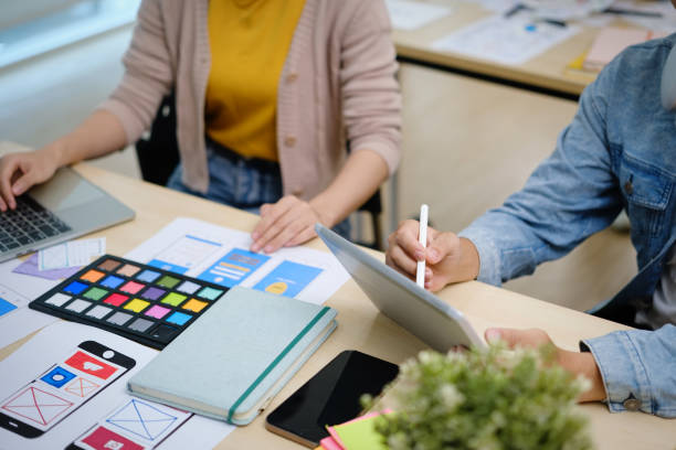 istock Group of young creative people working on new website wireframe, planning application development at office. 1589153323