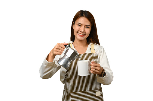 Image of young female barista wearing apron holding moka pot isolated on white background..